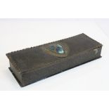 An Arts and crafts / Art Nouveau leather glove box with central hammered metal shaped plaque inset