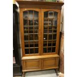 Early 20th century Oak Glazed Bookcase, the two glazed doors opening to reveal Three Adjustable