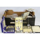 A box containing a quantity of silver plate to include cutlery, toast racks, cruet sets etc.