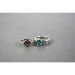 Two Silver Rings, one set with Blue Topaz