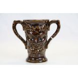 19th century treacle glaze loving cup decorated with two faces of Bacchus