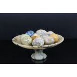 Stone footed bowl and a quantity of stone eggs