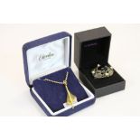 A yellow metal concorde pendant within original display box together with a boxed brooch.