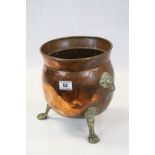 Vintage Copper Cylindrical Planter with Brass Lion Mask Handles and raised on Three Brass Lion Paw