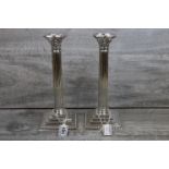 Pair of silver plated Corinthian column candlesticks, classical bead borders, acanthus leaf sconce