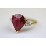 Ruby and diamond 18ct yellow gold ring, the pear shaped glass filled ruby measuring approximately