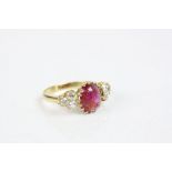 Ruby and diamond unmarked yellow gold ring, the central cabochon cut oval ruby measuring