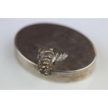 Silver oval pill box with cast fly decoration to lid forming the catch, gilt interior, makers