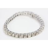 Champagne diamond 14ct white gold line bracelet, formed of thirty-six round brilliant cut