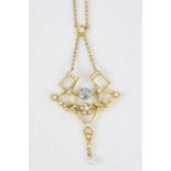 Edwardian Art Nouveau aquamarine and seed pearl 15ct yellow gold pendant necklace, the sinuous