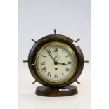 Vintage key wind Brass Ship's Bulkhead Clock in later wooden Ship's Wheel mount & stand, approx 26.