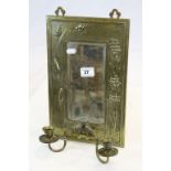 Art Nouveau brass framed bevelled wall mirror with candle sconces