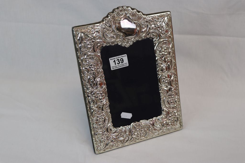 A hallmarked silver easel back photograph frame.