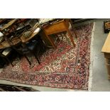 Iranian Wool Red Ground Rug decorated with Geometric Patterns, 300cms x 214cms