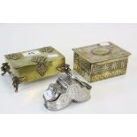 Two brass cigarette boxes, one in Arts and Craft style and other with Griffin feet, plus a white