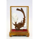 Oriental Cased Hand Painted Egg mounted on a carved wooden stand