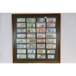A collection of framed and glazed world banknotes.