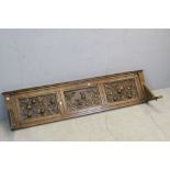 Oak Backboard comprising three panels heavily carved with fruits and rabbits, 150cms long x 35cms