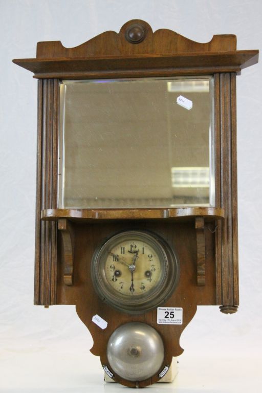 Oak framed bevelled glass wall Mirror, set with key wind German Alarm clock & Bell, measures