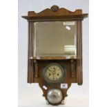 Oak framed bevelled glass wall Mirror, set with key wind German Alarm clock & Bell, measures