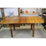 Pine Extending Dining Table with one additional pull-up leaf and raised on detachable turned legs,