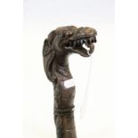 Carved two piece Oriental hard wood walking stick in the form of a dragon, approx. 97 cm