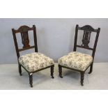 Pair of Victorian low chairs raised on turned legs with casters