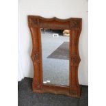 Carved Oak framed mirror in the Arts and Crafts style, 65cms x 39cms