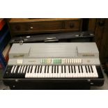 A vintage Farfisa Compact electronic keyboard within original travel case.