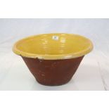 Large Antique Terracotta Dairy Bowl with Mustard Yellow Glaze to interior, 47cms diameter