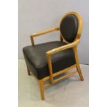 Light Oak Framed Elbow Chair, the oval back and seat with brown leather upholstery