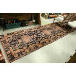 Eastern Dark Blue and Coral Ground Wool Rug decorated with stylised Animals, Flowers and Shapes,