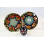 Two vintage Moorcroft Pottery Plates, with Berry & leaf patterns, each plate approximately 23.5cm