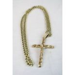 9ct yellow gold crucifix pendant, length approximately 8.5cm (including bale) on yellow metal curb