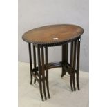 Early 20th century Nest of Three Tables, the oval tops with carved rims, raised on splayed square