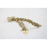 9ct yellow gold gate link bracelet with padlock clasp and safety chain, width approximately 10mm