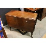 19th century Mahogany Drop Flap Table raised on Turned Fluted Tapering Legs and castors, 90cms