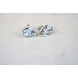 Pair of silver pear shaped blue topaz earrings