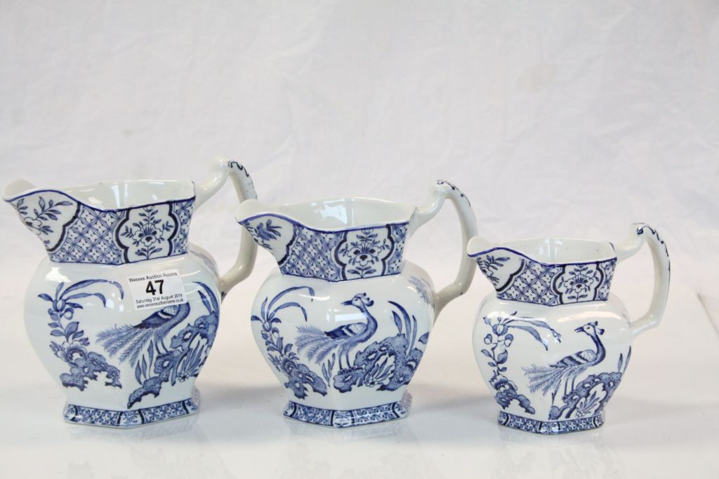 Three Wood & Sons blue & white graduating ceramic Jugs in "Yuan" pattern, the largest approx 17cm