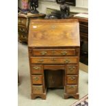 19th century Walnut and Crossbanded Kneehole Bureau, the hinged drop front opening to reveal a