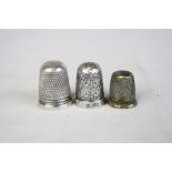 Two silver thimbles and one brass childs