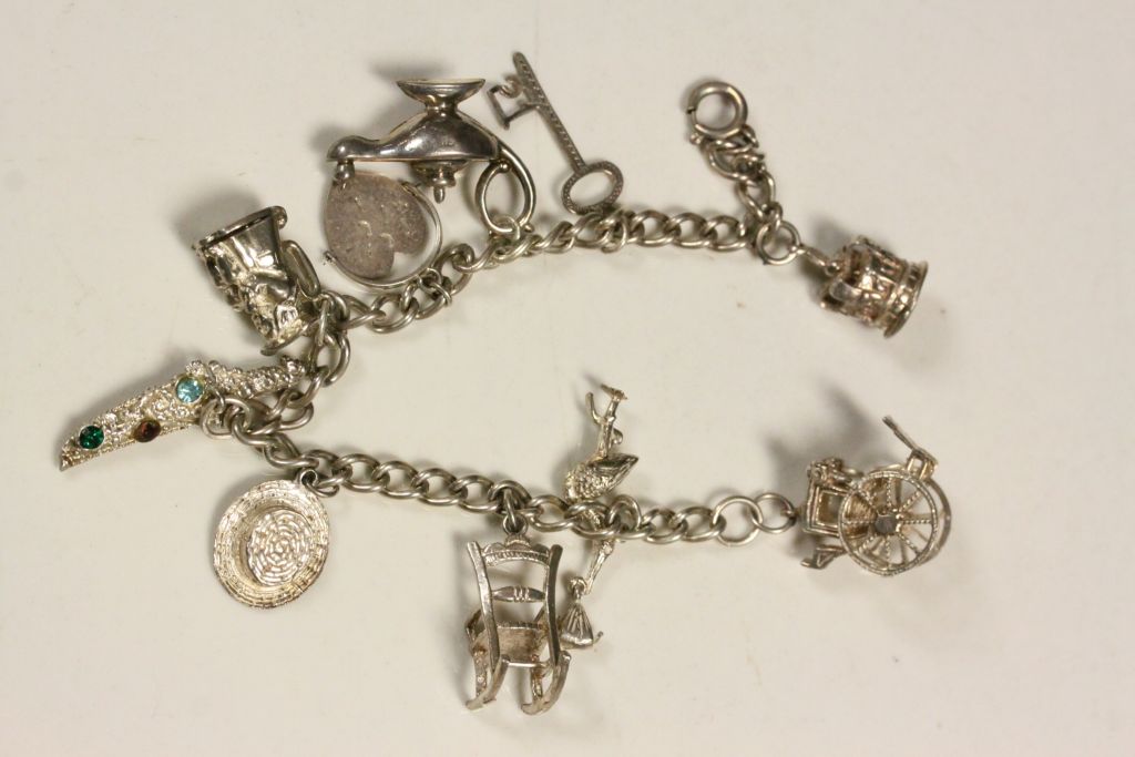 Hallmarked Silver Charm bracelet with various charms to include; Crown, Rocking Chair, Toby Jug etc