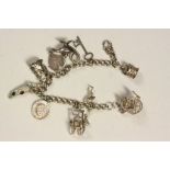 Hallmarked Silver Charm bracelet with various charms to include; Crown, Rocking Chair, Toby Jug etc