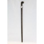 Antique walking stick of square form profusely carved to stem with stylized Lion Head handle