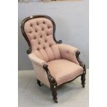 Victorian Mahogany Framed Button Back Armchair with Carved Scroll Arms and turned legs raised on