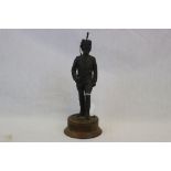A resin figure of a Royal Horse Artillery Officer on a wooden plinth by Peter Hicks