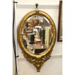 19th century oval Bevelled Glass Mirror with ornate Gilt painted frame & pair of Sconces to base,