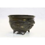 Patinated Chinese Bronze bowl with raised Dragon & Phoenix decoration, stands approx 9cm