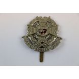 A Pagri Badge To The Border Regiment. White Metal With Brass Slider.