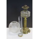 An antique table top oil lamp with Art Nouveau base, with twisted stem and glass well